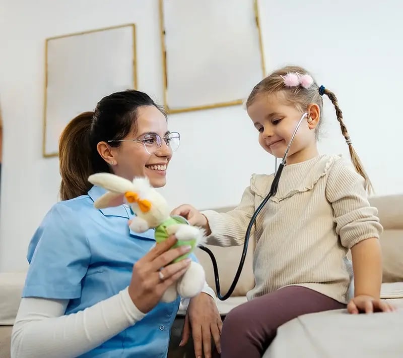 Child plays doctor with a healthcare provider.