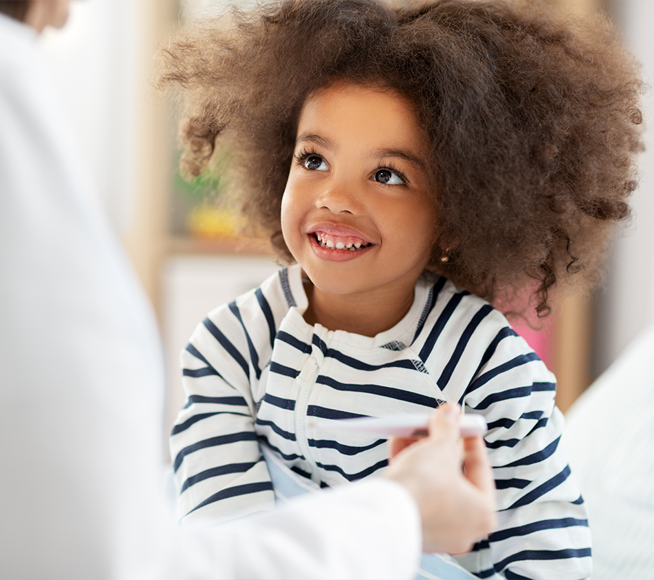 Little girl getting temperature taken